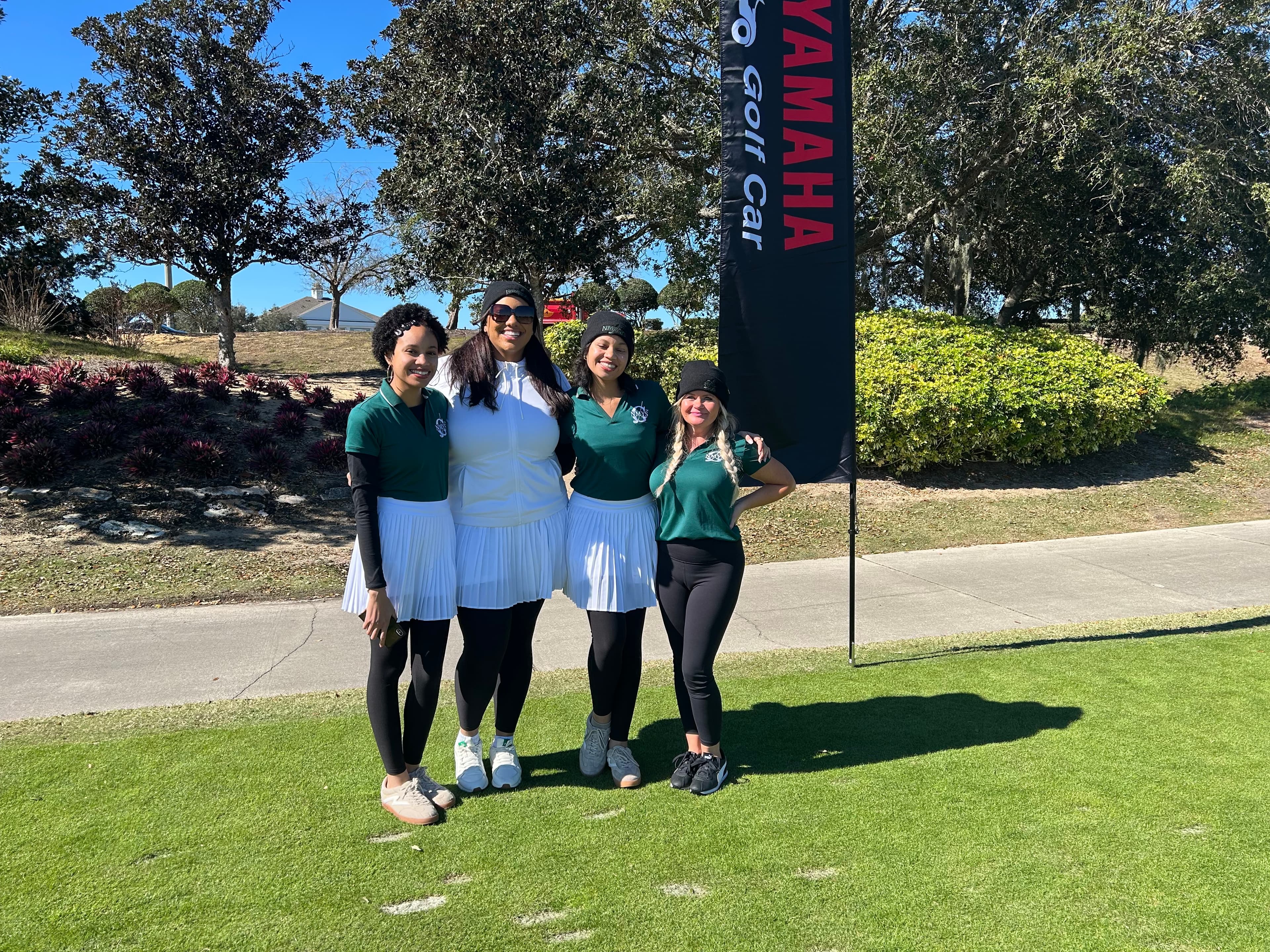 NMYSG Ambassadors posing at a golf event